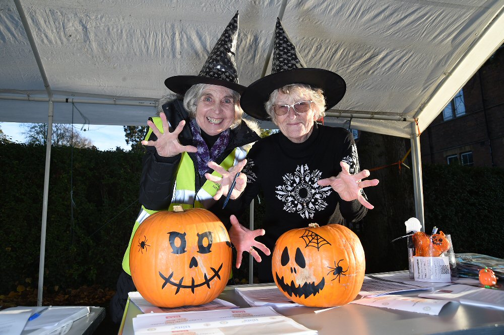 Photographs: Two wizzened witches in front of their pumkin lamps.